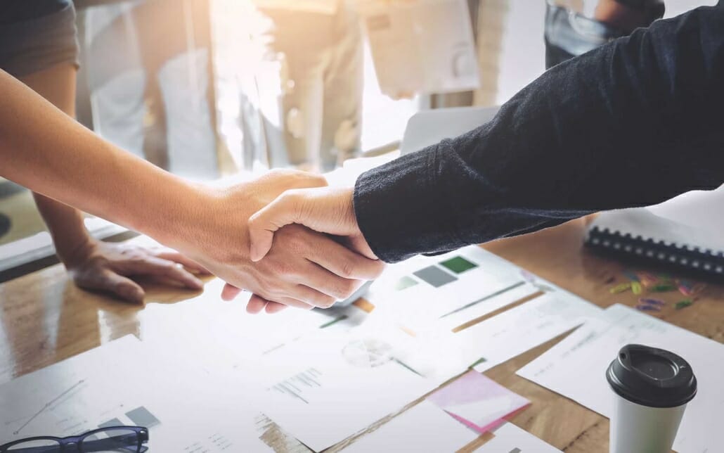 Close up view of two people shaking hands