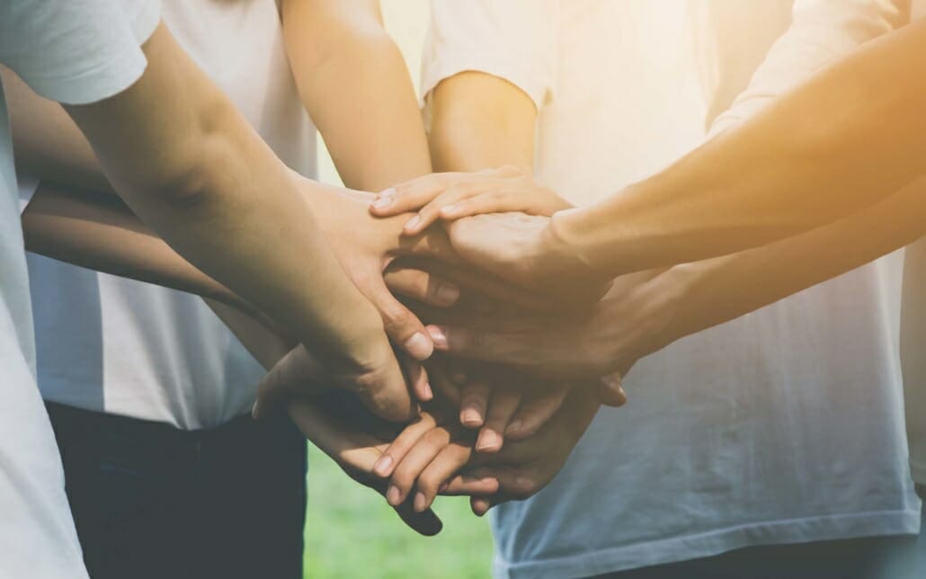 View of multiple people having hands in the middle